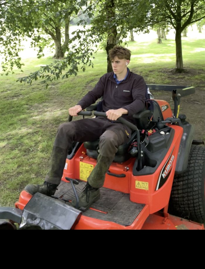 Apex Landscapes ride-on mower in use