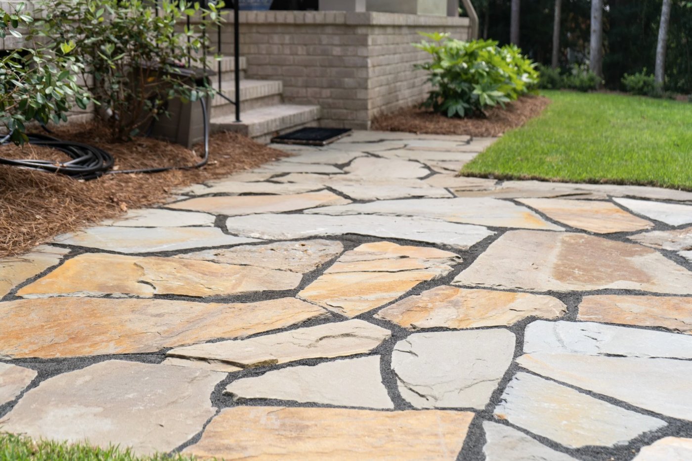 Natural stone flagstone path with brick steps and planting