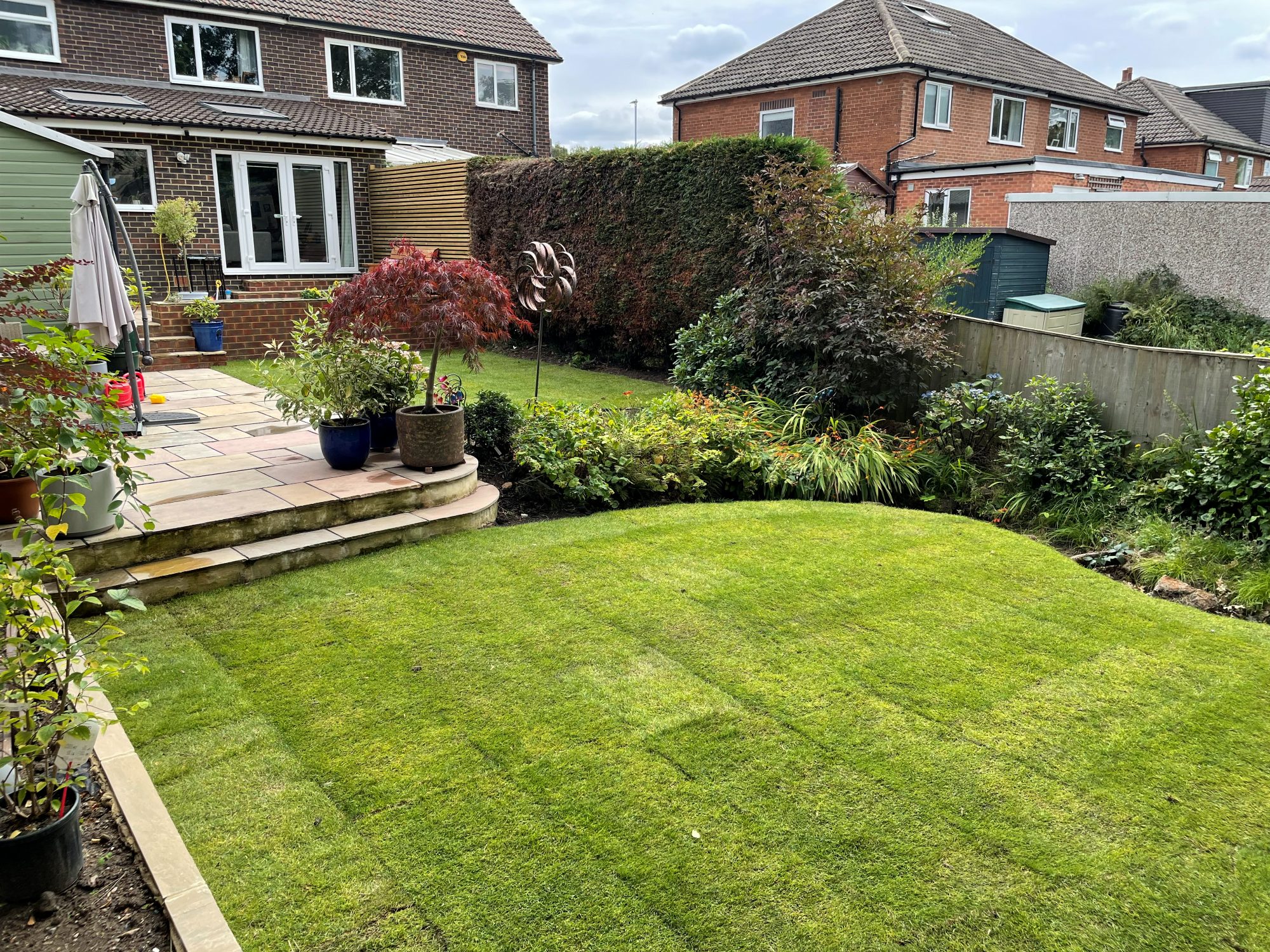 Finished garden makeover with new lawn, patio steps and borders