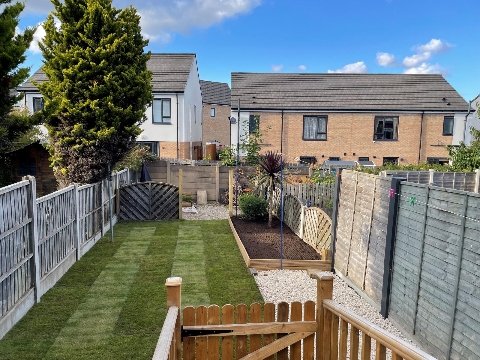 Long, freshly turfed back garden lawn with mowing stripes, North Leeds