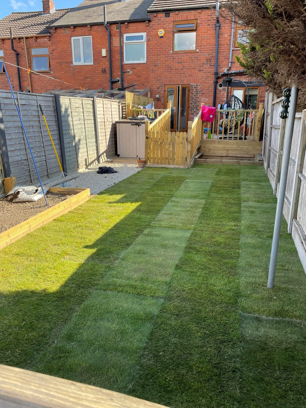 Narrow terraced back garden transformed with new striped turf