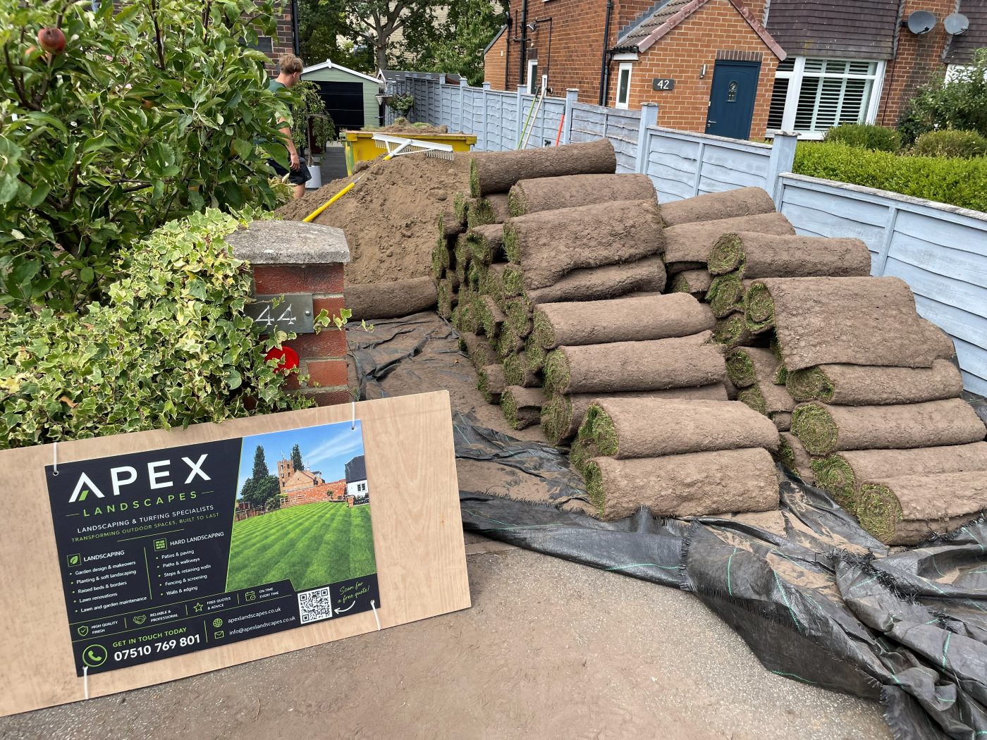 Fresh turf rolls delivered to a Leeds garden with the Apex Landscapes sign